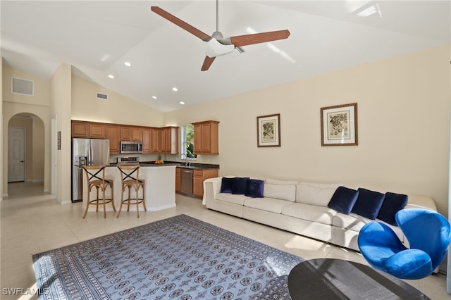 living room with high vaulted ceiling, sink, light tile patterned floors, and ceiling fan