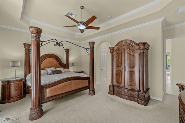 bedroom featuring ornamental molding, light colored carpet, a raised ceiling, and ceiling fan