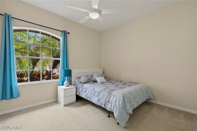 bedroom with light carpet and ceiling fan