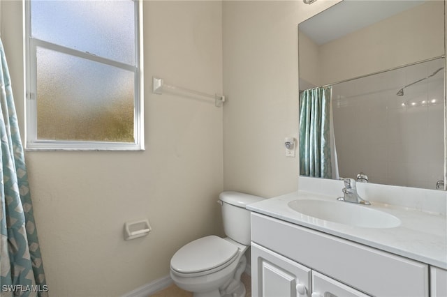 bathroom featuring vanity, a shower with shower curtain, and toilet