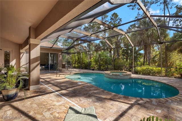 view of swimming pool featuring a lanai, a patio area, and an in ground hot tub