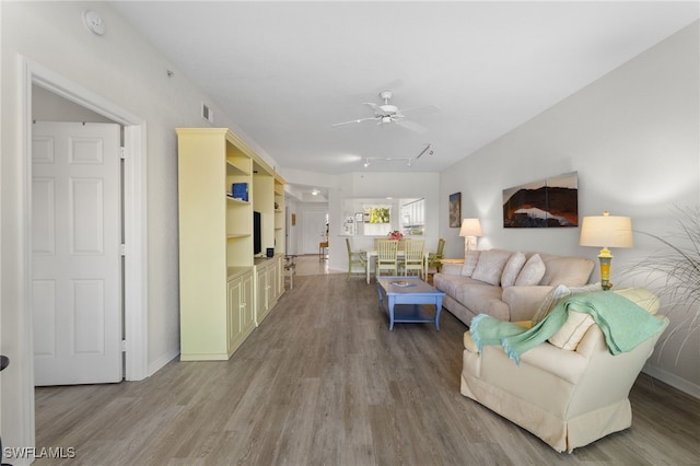 living room with ceiling fan and hardwood / wood-style floors