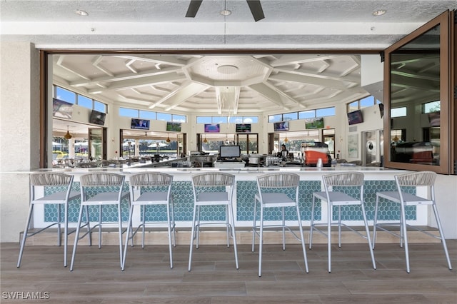 interior space featuring a high ceiling and ceiling fan