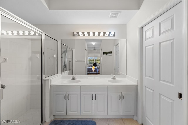 bathroom featuring an enclosed shower, vanity, tile patterned floors, and ceiling fan