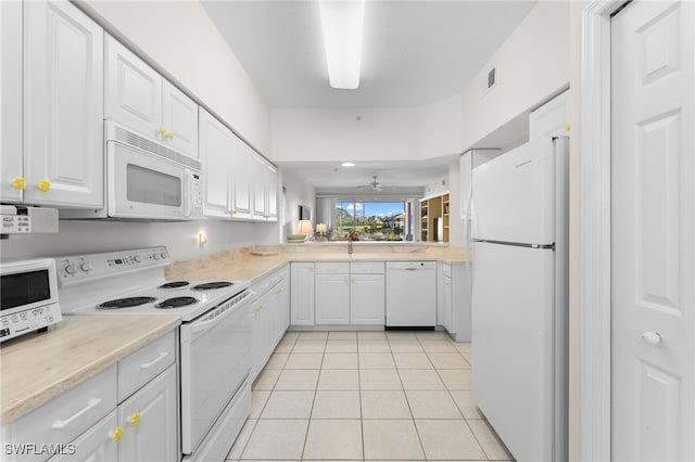 kitchen with light tile patterned flooring, ceiling fan, white cabinets, and white appliances