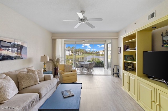 living room with light hardwood / wood-style flooring and ceiling fan