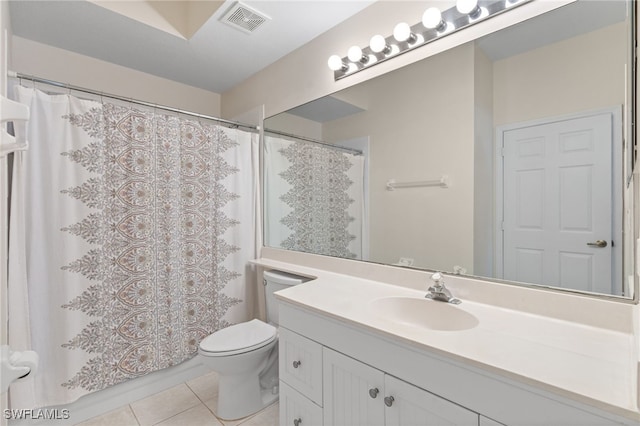 bathroom with vanity, toilet, curtained shower, and tile patterned flooring