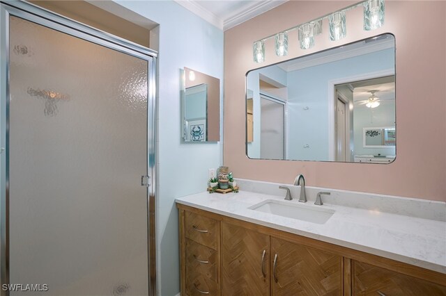 full bath with ornamental molding, a shower stall, and vanity