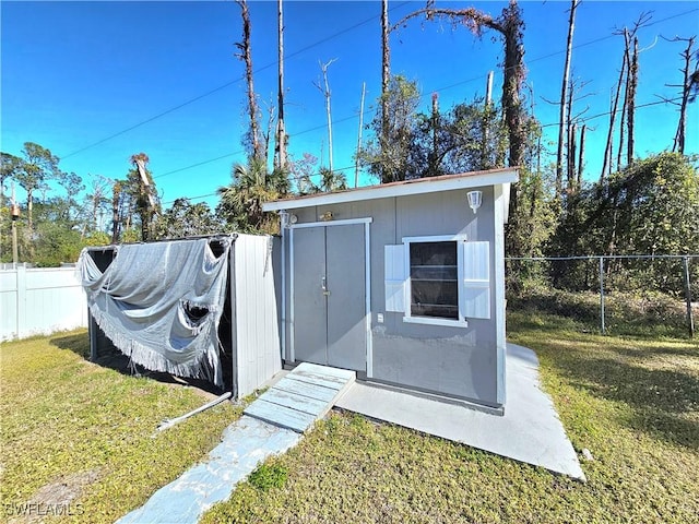 view of outdoor structure with a lawn