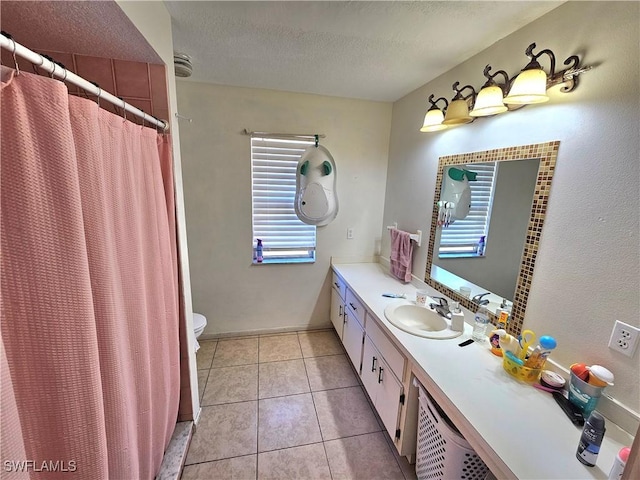 bathroom featuring a shower with shower curtain, vanity, a textured ceiling, tile patterned floors, and toilet