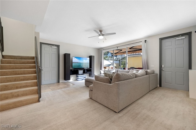 carpeted living room with ceiling fan