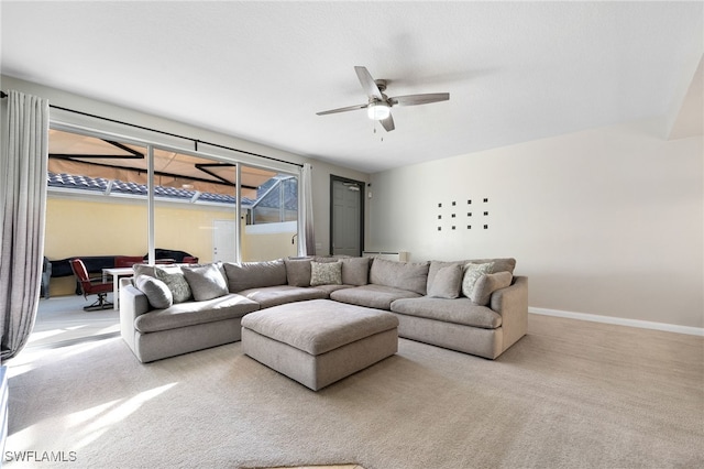 living room featuring light carpet, a baseboard heating unit, and ceiling fan