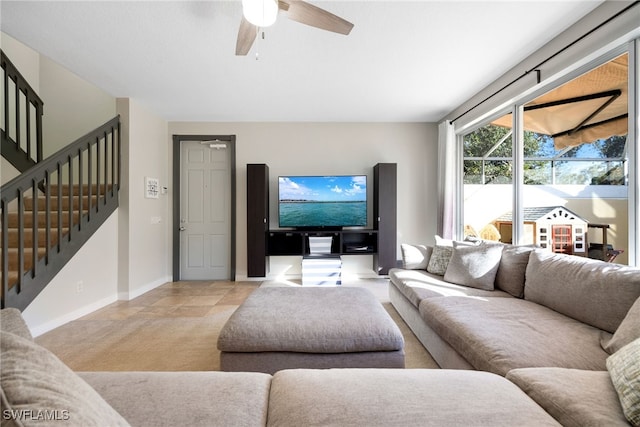 living room featuring light colored carpet and ceiling fan