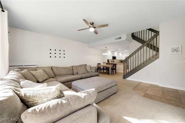 living room with ceiling fan and carpet flooring