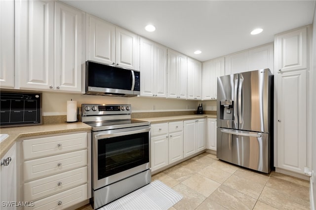 kitchen with white cabinetry and stainless steel appliances