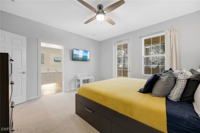 carpeted bedroom featuring connected bathroom and ceiling fan