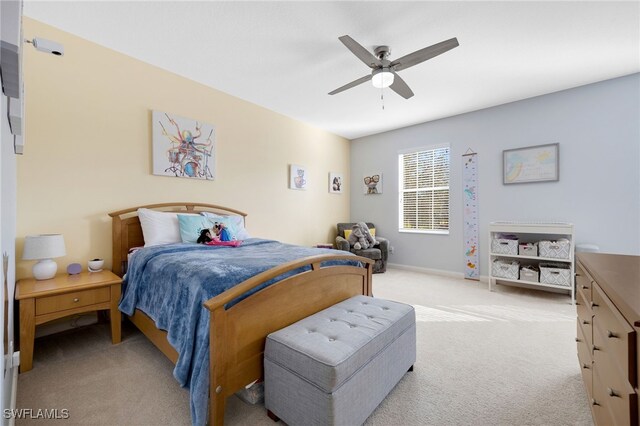 bedroom featuring light colored carpet and ceiling fan