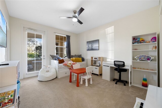 recreation room with light carpet and ceiling fan