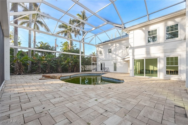 view of pool featuring a patio area and glass enclosure