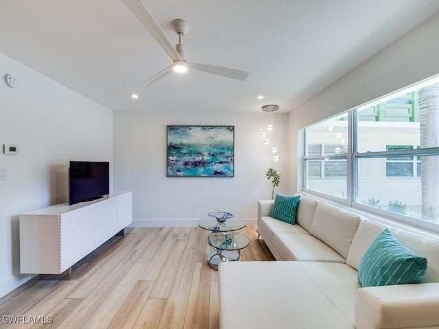 living room with ceiling fan and light hardwood / wood-style floors