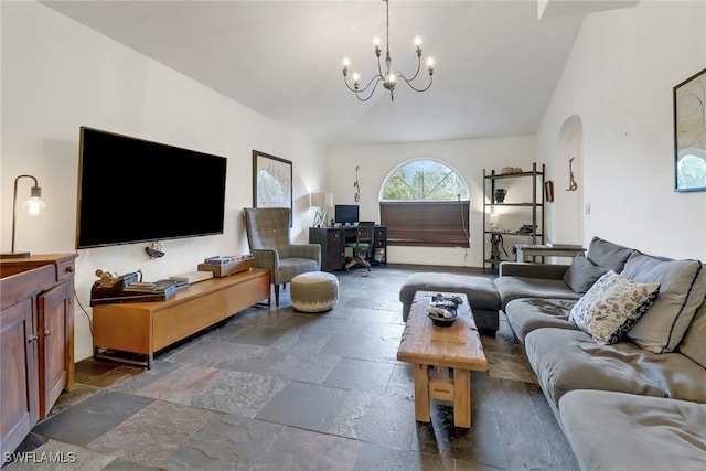 living room featuring a notable chandelier and vaulted ceiling