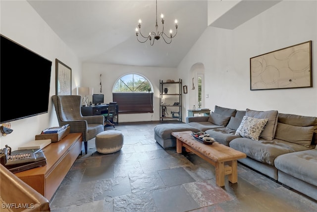 living room featuring an inviting chandelier and high vaulted ceiling