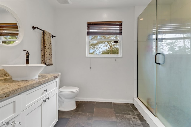 bathroom with vanity, toilet, and walk in shower