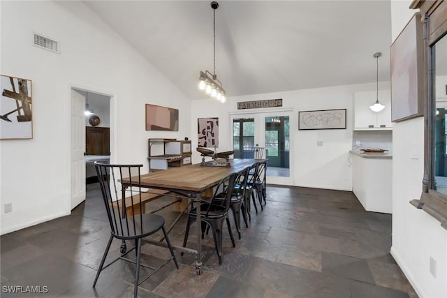 dining area featuring french doors and high vaulted ceiling