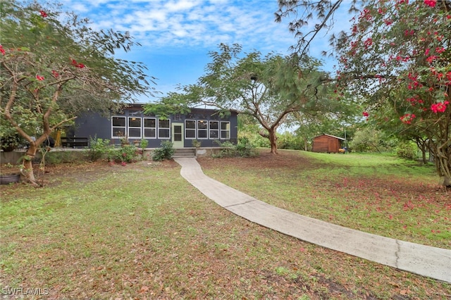 view of front facade featuring a front lawn and a sunroom