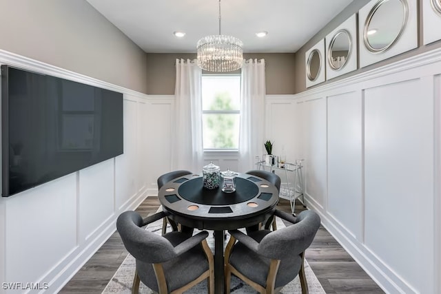 dining space featuring dark hardwood / wood-style flooring and an inviting chandelier