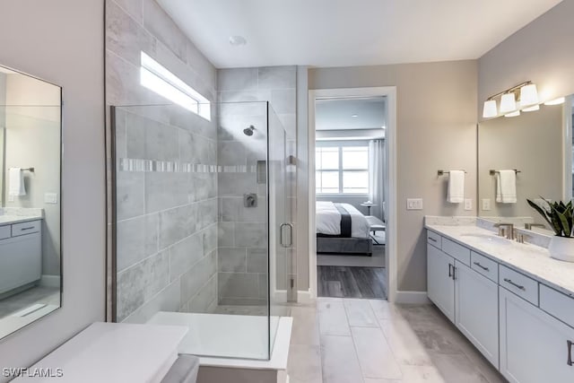 bathroom featuring a healthy amount of sunlight, an enclosed shower, and vanity