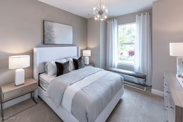 bedroom with an inviting chandelier and light colored carpet