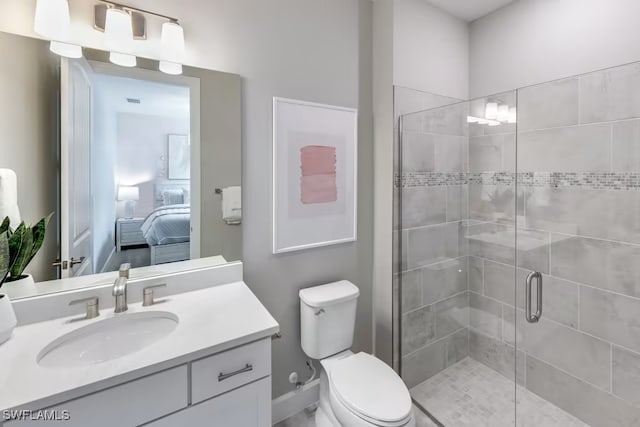 bathroom with walk in shower, vanity, and toilet