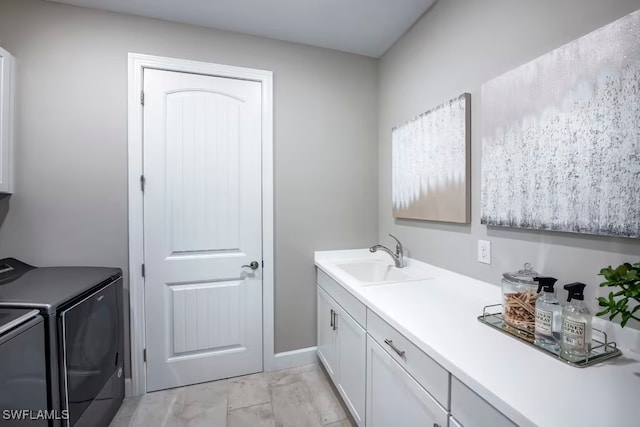 bathroom with washing machine and dryer and vanity