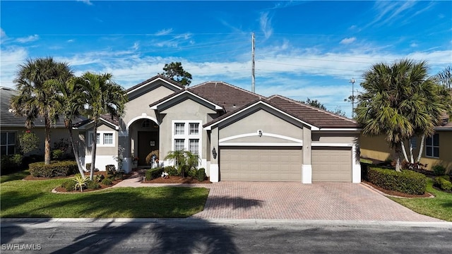 view of front facade with a garage and a front lawn