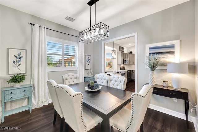 dining space featuring dark wood-type flooring