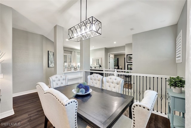 dining room with hardwood / wood-style flooring and a chandelier