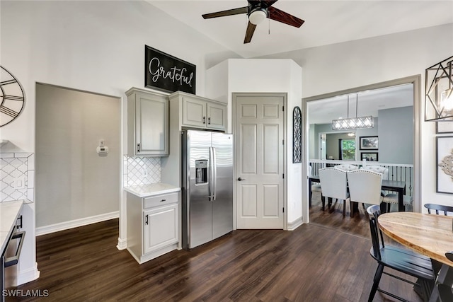 kitchen with pendant lighting, dark hardwood / wood-style floors, stainless steel fridge with ice dispenser, and decorative backsplash