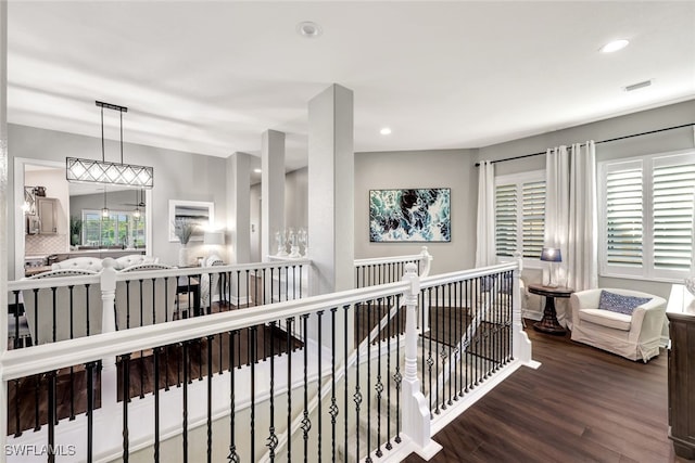 corridor with hardwood / wood-style flooring