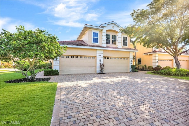 view of front property with a garage and a front yard