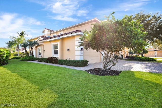 view of front of house featuring a garage and a front lawn