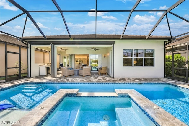 rear view of property featuring outdoor lounge area, a patio area, ceiling fan, and a lanai