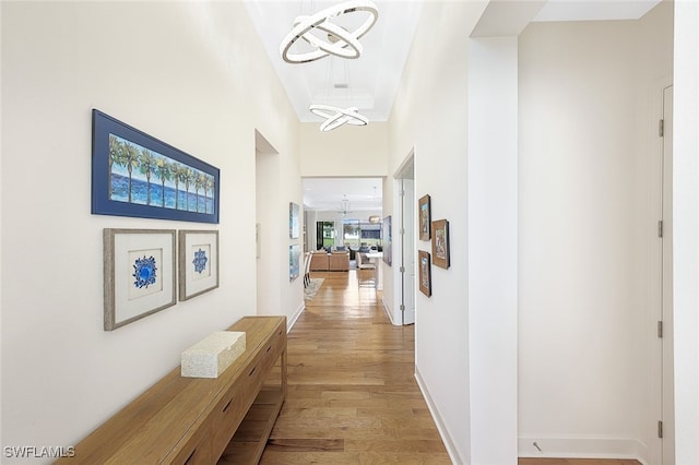 hallway with light hardwood / wood-style flooring