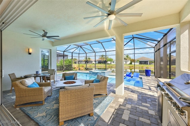 view of patio with area for grilling, an outdoor fire pit, a swimming pool with hot tub, and exterior kitchen