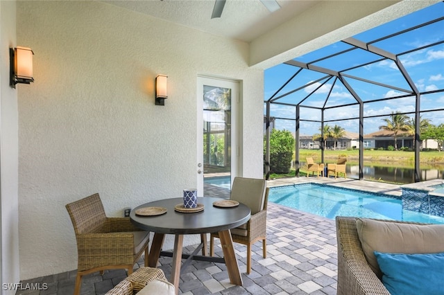 view of pool with a water view, a lanai, and a patio