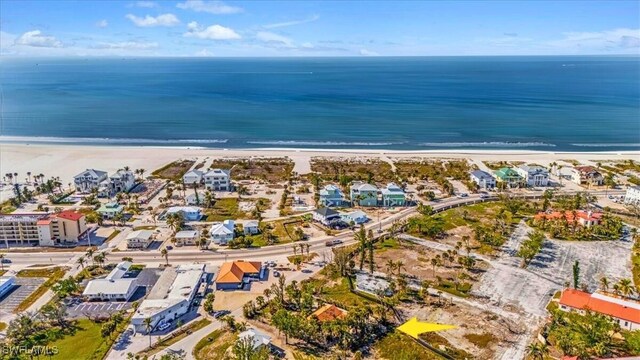 drone / aerial view featuring a water view and a beach view