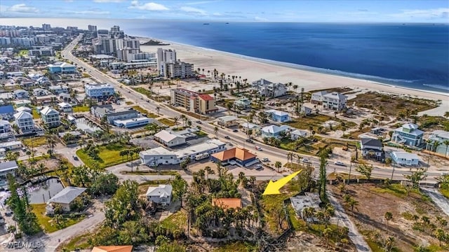 drone / aerial view with a water view and a beach view