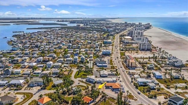 drone / aerial view with a beach view and a water view