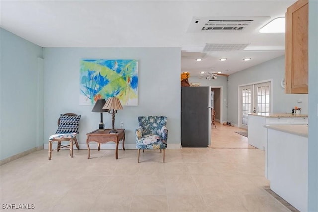 sitting room featuring french doors, visible vents, and baseboards