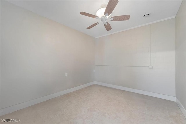 empty room with ceiling fan and baseboards